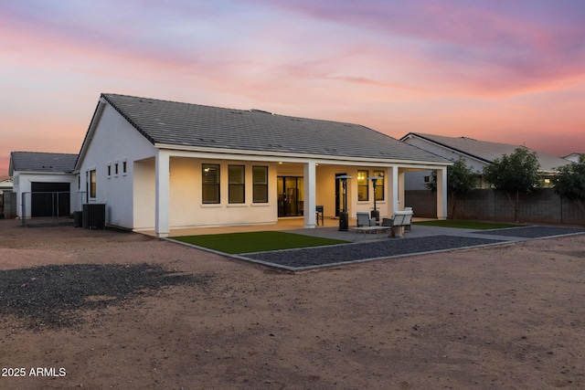 1294 E Ln Fortuna Ct, San Tan Valley, AZ 85140 - back of property at dusk featuring a tiled roof, a patio, and stucco siding