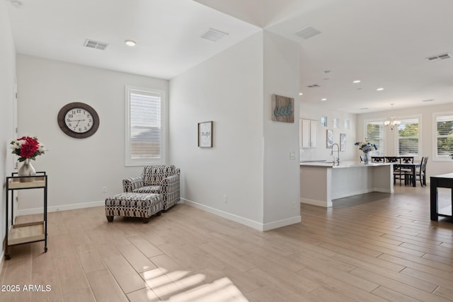 1294 E Ln Fortuna Ct, San Tan Valley, AZ 85140 - sitting room with light wood-style flooring, a chandelier, and recessed lighting