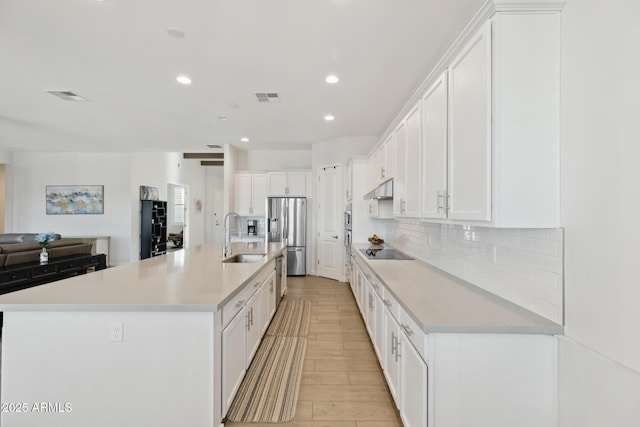 1294 E Ln Fortuna Ct, San Tan Valley, AZ 85140 - kitchen with stainless steel fridge, under cabinet range hood, white cabinetry, backsplash, and recessed lighting