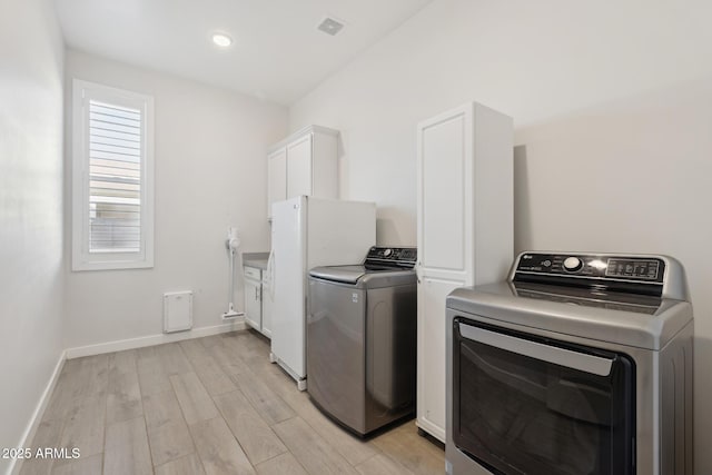 1294 E Ln Fortuna Ct, San Tan Valley, AZ 85140 - laundry room with washer and dryer, light wood finished floors, and cabinet space