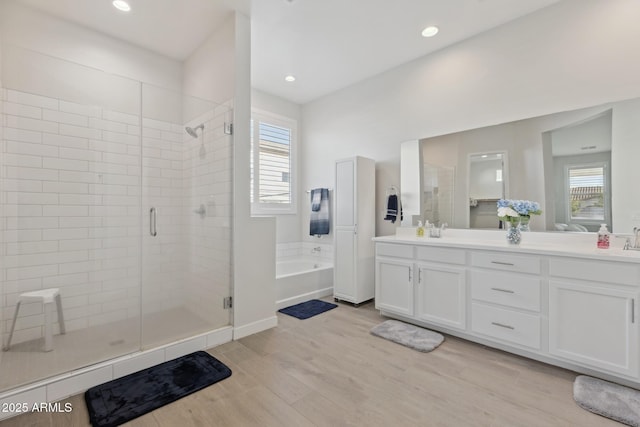1294 E Ln Fortuna Ct, San Tan Valley, AZ 85140 - full bath featuring a stall shower, a bath, double vanity, wood finished floors, and recessed lighting