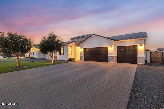 1294 E Ln Fortuna Ct, San Tan Valley, AZ 85140 - single story home with an attached garage, decorative driveway, solar panels, a front lawn, and stucco siding
