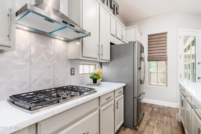 6621 S Balboa Dr, Gilbert, AZ 85298 - kitchen with wall chimney exhaust hood, stainless steel appliances, backsplash, and light countertops