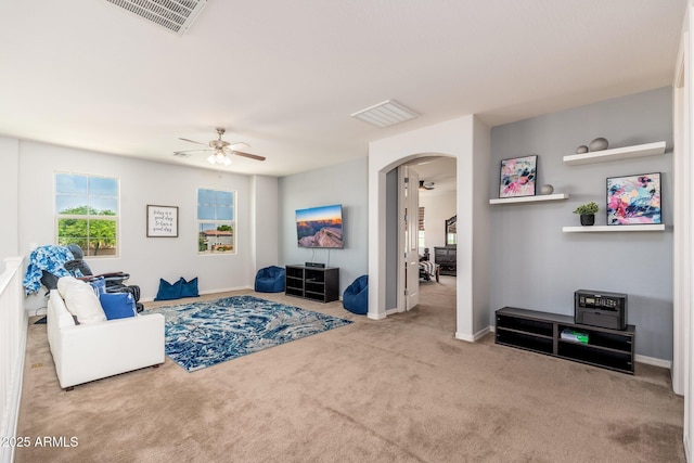 6621 S Balboa Dr, Gilbert, AZ 85298 - living room with arched walkways, healthy amount of natural light, carpet flooring, and ceiling fan