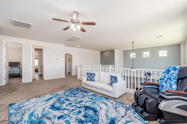 6621 S Balboa Dr, Gilbert, AZ 85298 - living room with ceiling fan, carpet, arched walkways, and baseboards