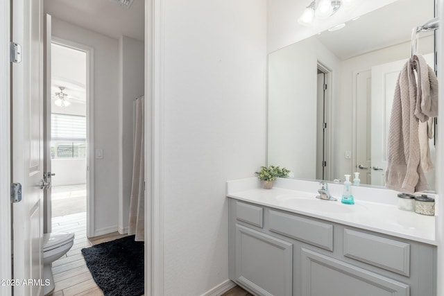 6621 S Balboa Dr, Gilbert, AZ 85298 - full bathroom featuring vanity, toilet, wood finished floors, and baseboards