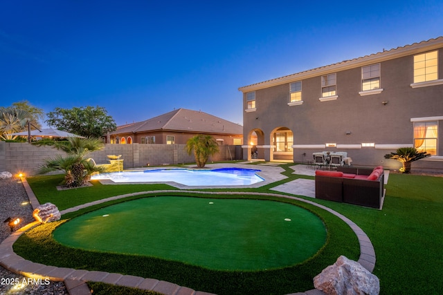 6621 S Balboa Dr, Gilbert, AZ 85298 - pool at dusk featuring a putting green, a patio area, and a fenced backyard