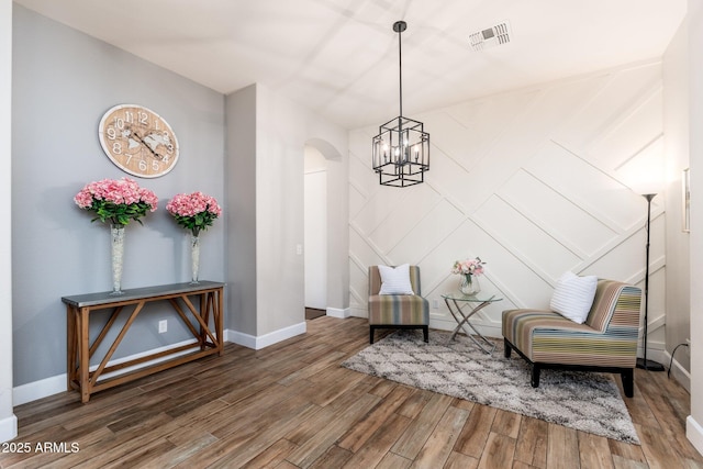 6621 S Balboa Dr, Gilbert, AZ 85298 - sitting room featuring a chandelier, wood finished floors, baseboards, and arched walkways