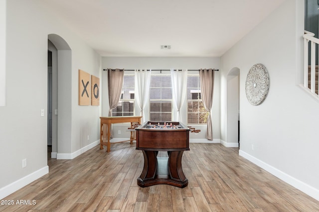 6621 S Balboa Dr, Gilbert, AZ 85298 - game room with arched walkways, light wood finished floors, and baseboards