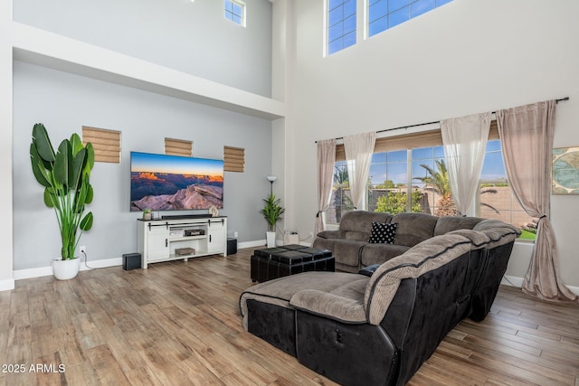 6621 S Balboa Dr, Gilbert, AZ 85298 - living area with a high ceiling, wood finished floors, healthy amount of natural light, and baseboards