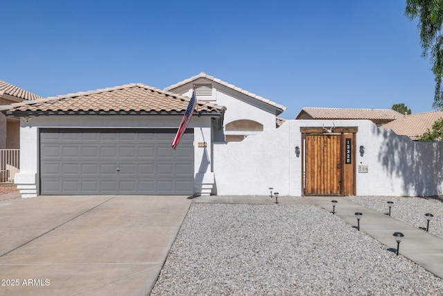 13320 N 82nd Dr, Peoria, AZ 85381 - mediterranean / spanish house with a fenced front yard, an attached garage, stucco siding, concrete driveway, and a tiled roof