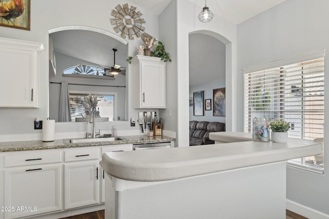 13320 N 82nd Dr, Peoria, AZ 85381 - kitchen with a sink, arched walkways, lofted ceiling, white cabinets, and a ceiling fan