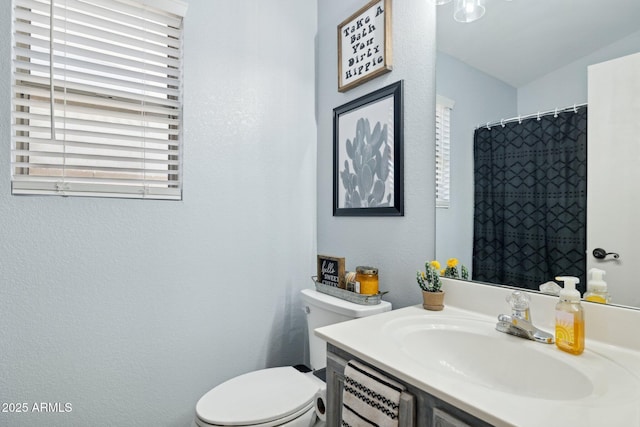 13320 N 82nd Dr, Peoria, AZ 85381 - bathroom featuring toilet, vanity, and a textured wall