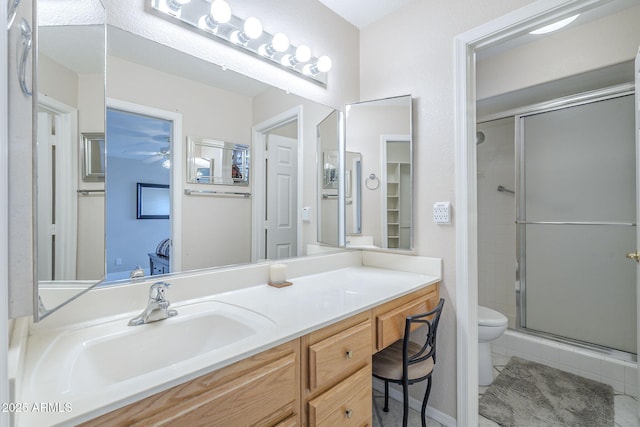 full bath with toilet, a ceiling fan, tile patterned flooring, a shower stall, and vanity