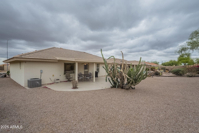 back of house featuring central AC, a patio area, stucco siding, and a tile roof