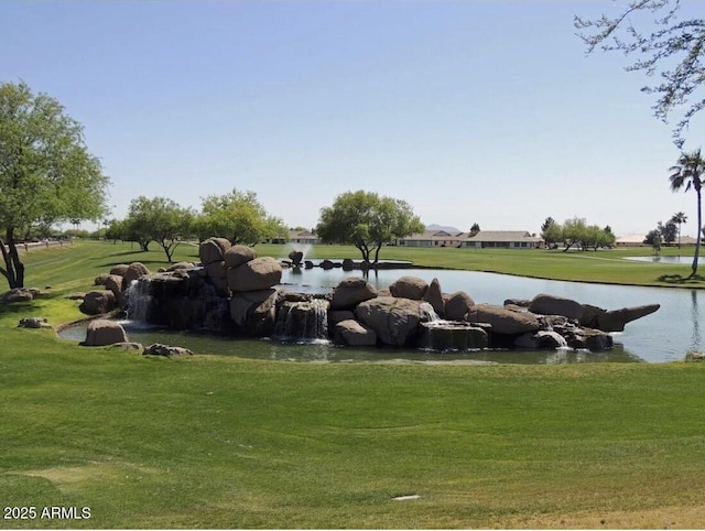 view of home's community with a yard and a water view