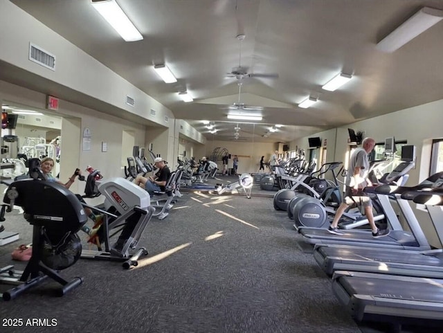 gym with vaulted ceiling, ceiling fan, and visible vents