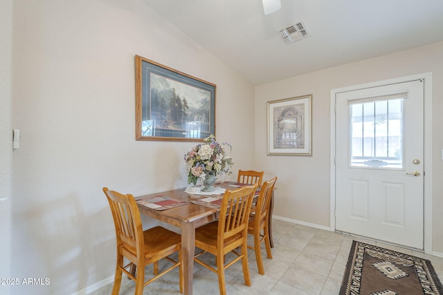 dining room with baseboards, light tile patterned floors, and visible vents