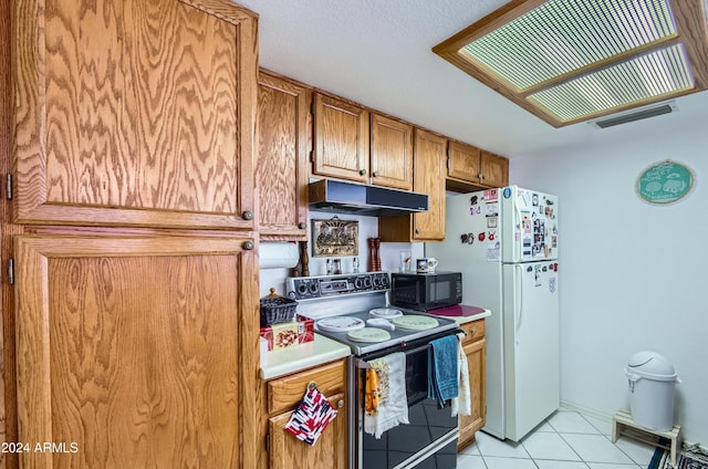 kitchen featuring light tile patterned floors, white appliances, and ventilation hood