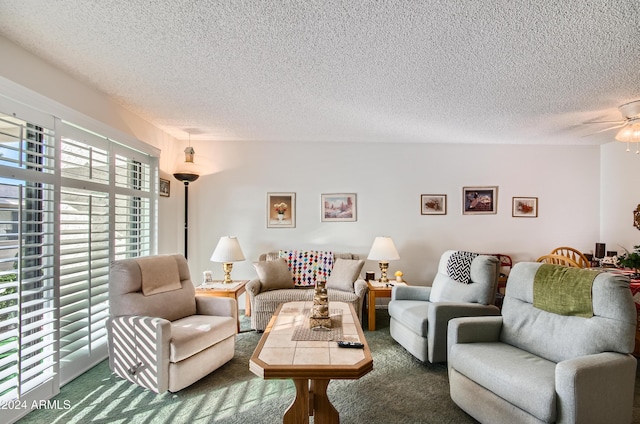 carpeted living room with ceiling fan, a healthy amount of sunlight, and a textured ceiling