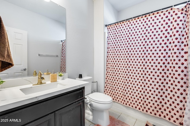 bathroom with a shower with shower curtain, vanity, toilet, and tile patterned floors