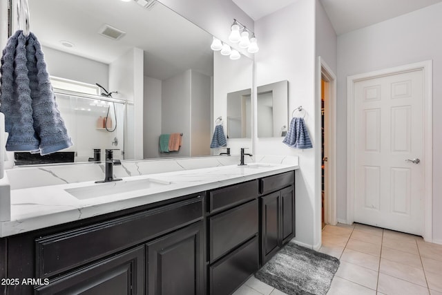 bathroom with tile patterned floors and vanity