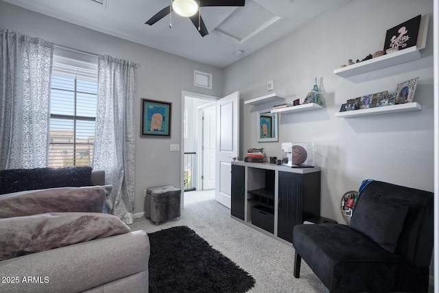 interior space featuring attic access, carpet, visible vents, and a ceiling fan