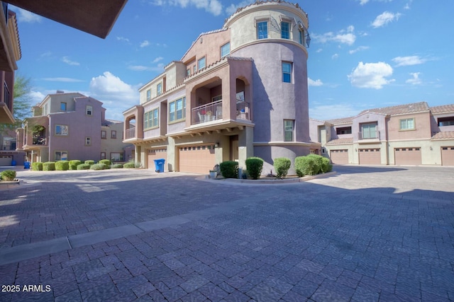 exterior space with a garage, driveway, and a residential view