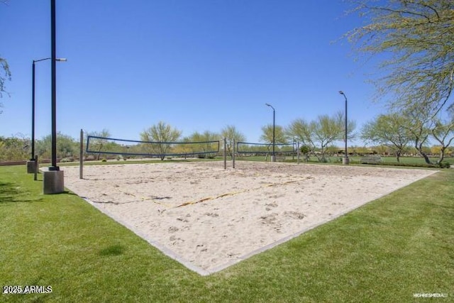 view of home's community featuring volleyball court and a yard