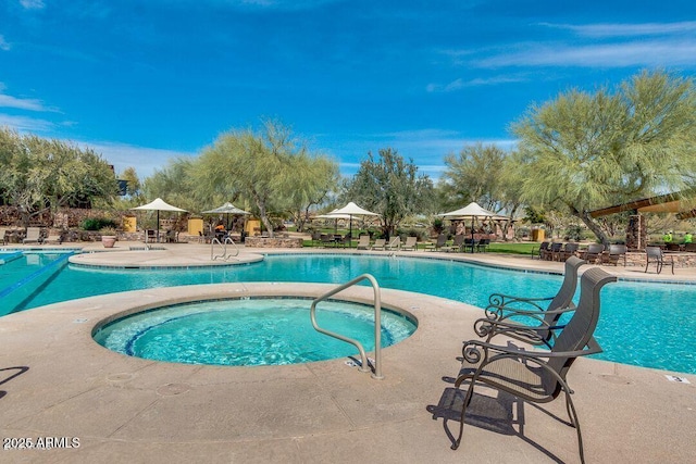 community pool featuring a community hot tub, a patio, and a gazebo