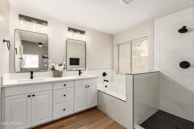 1114 N Leland Ct, Gilbert, AZ 85233 - bathroom featuring a garden tub, healthy amount of natural light, tiled shower, and double vanity