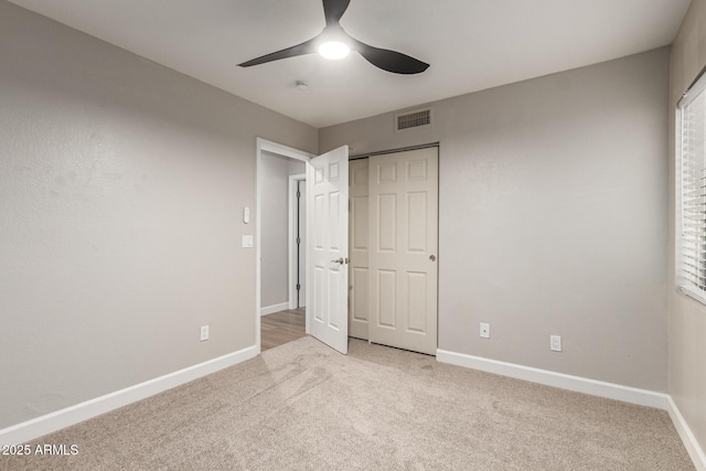 1114 N Leland Ct, Gilbert, AZ 85233 - unfurnished bedroom featuring light carpet, baseboards, and ceiling fan