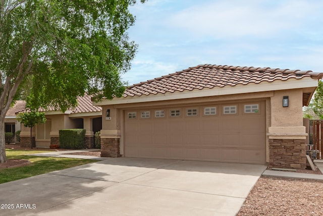 1114 N Leland Ct, Gilbert, AZ 85233 - view of front of home featuring driveway, stone siding, a tiled roof, and an attached garage