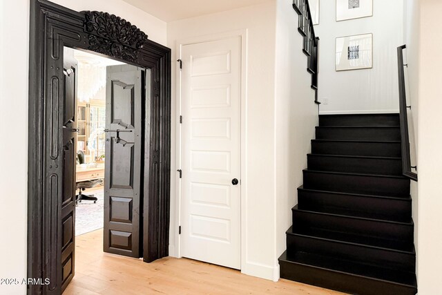 stairway with wood finished floors