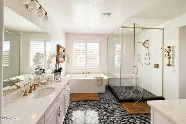 bathroom with vanity, a shower stall, and a freestanding bath