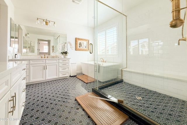 bathroom with a shower stall, a freestanding tub, and vanity