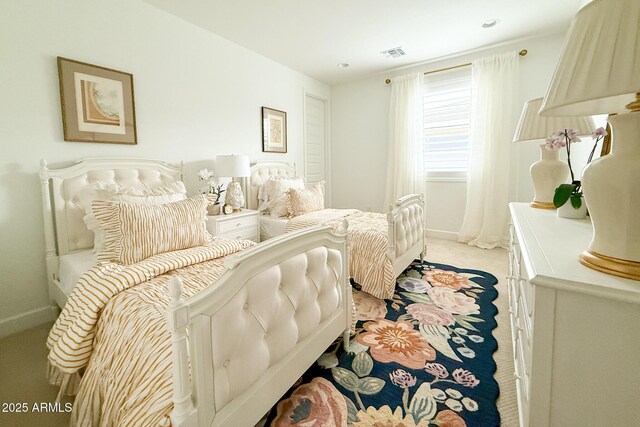 bedroom featuring light colored carpet and baseboards