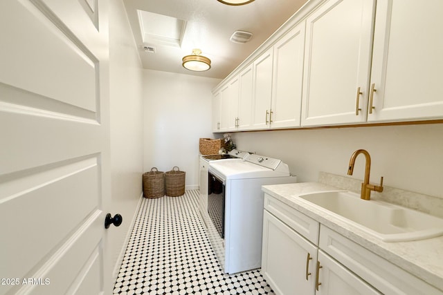 washroom featuring independent washer and dryer and cabinet space