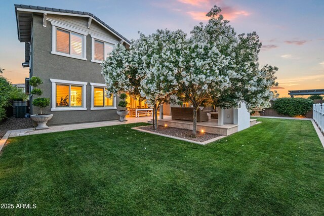 rear view of house with an outdoor hangout area, a patio, stucco siding, and cooling unit