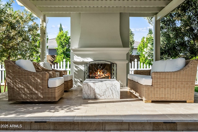 view of patio / terrace featuring a lit fireplace