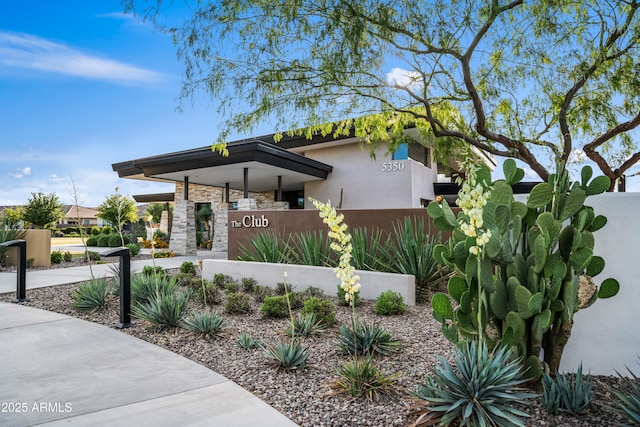 view of front facade featuring fence and stucco siding