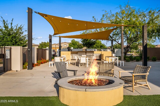view of patio / terrace featuring an outdoor fire pit and fence
