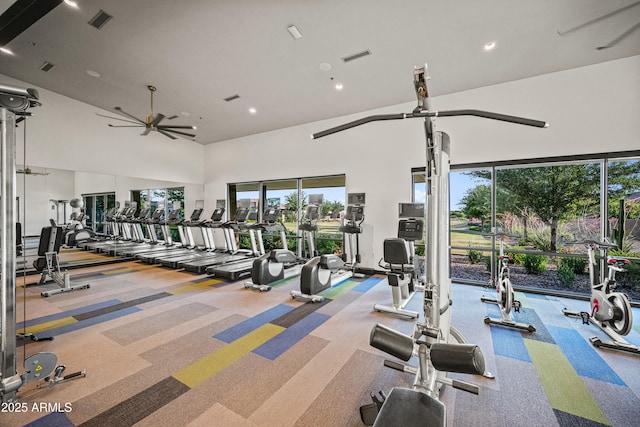 workout area featuring a towering ceiling, ceiling fan, carpet, and recessed lighting
