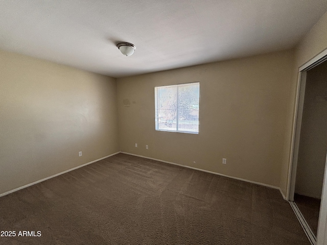 7126 N 19th Ave Unit 108, Phoenix, AZ 85021 - unfurnished room featuring dark carpet and baseboards