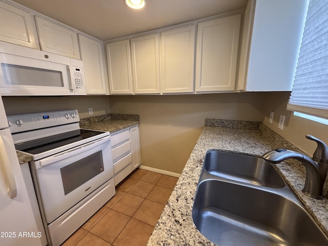 7126 N 19th Ave Unit 108, Phoenix, AZ 85021 - kitchen featuring white appliances, a sink, white cabinetry, light tile patterned flooring, and baseboards