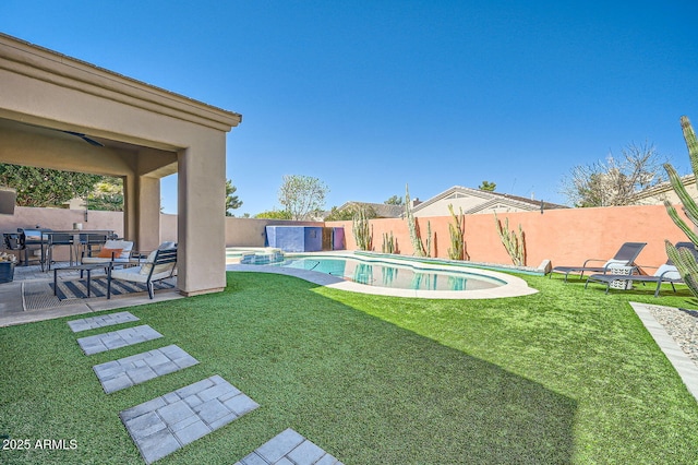 view of yard with a patio area, a fenced backyard, and a pool with connected hot tub