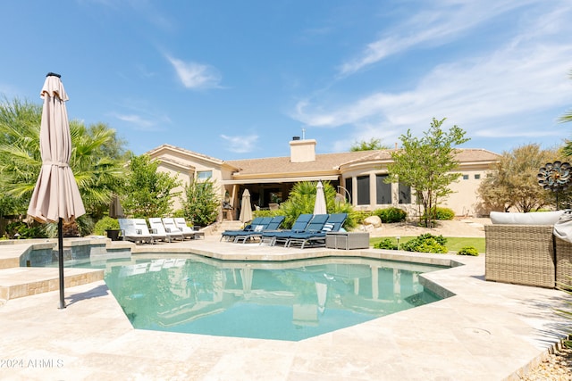 view of swimming pool featuring a patio area and an outdoor kitchen