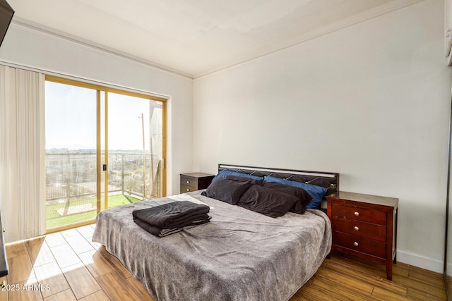 bedroom with access to outside and light hardwood / wood-style floors