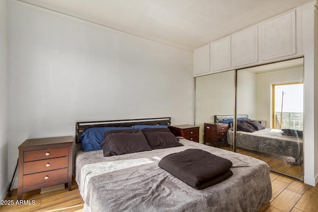 bedroom featuring light hardwood / wood-style floors and a closet