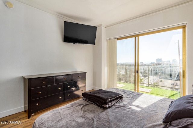 bedroom featuring access to outside and light wood-type flooring